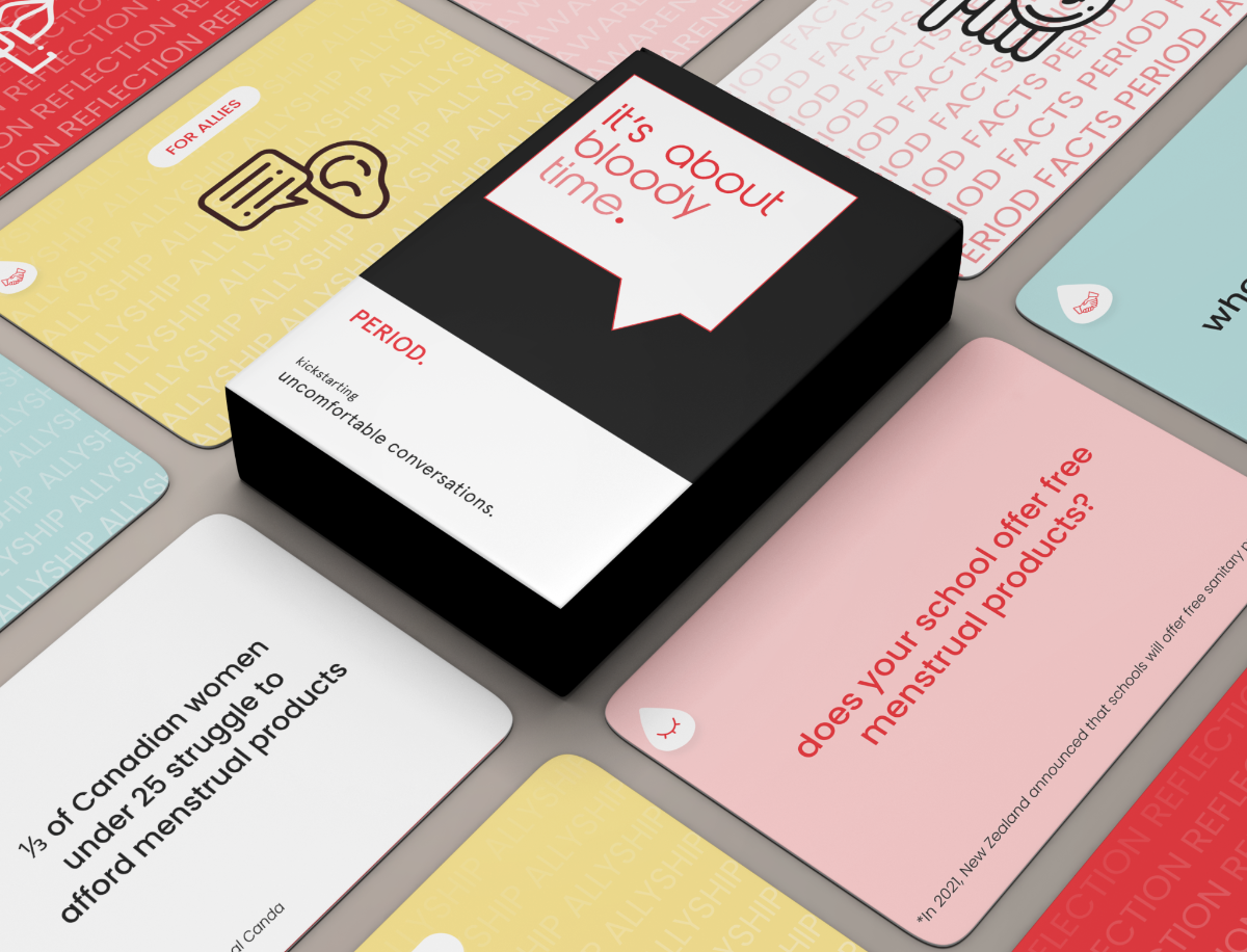 A black deck of cards of the game "it's about bloody time" . individual cards are placed around the deck. 